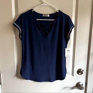 blue top with crossed neckline and jeweled sleeves